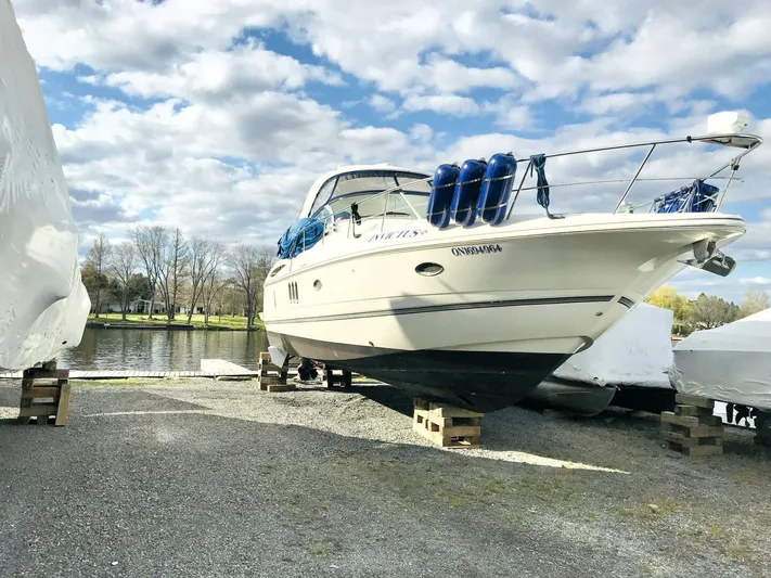  Yacht Photos Pics 2006 Cruisers Yachts 420 Express on dry dock near a scenic waterfront.