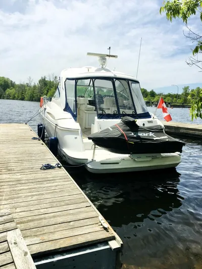  Yacht Photos Pics 2006 Cruisers Yachts 420 Express docked by a serene lake.