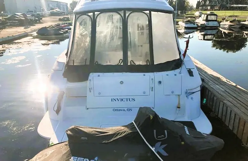  Yacht Photos Pics 2006 Cruisers Yachts 420 Express docked, rear view with watercraft, sunny marina setting.