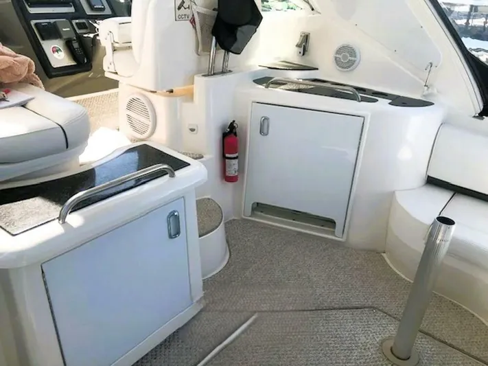  Yacht Photos Pics 2006 Cruisers Yachts 420 Express interior with seating, storage, and fire extinguisher.