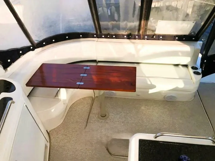  Yacht Photos Pics 2006 Cruisers Yachts 420 Express interior with white seating and wooden table.