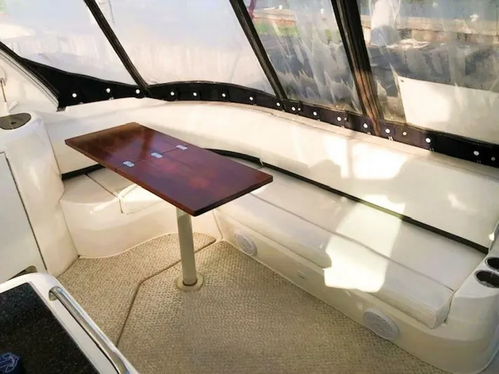  Yacht Photos Pics 2006 Cruisers Yachts 420 Express interior with white seating and wooden table.