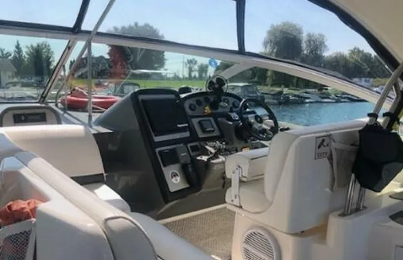  Yacht Photos Pics 2006 Cruisers Yachts 420 Express helm with modern controls and waterfront view.