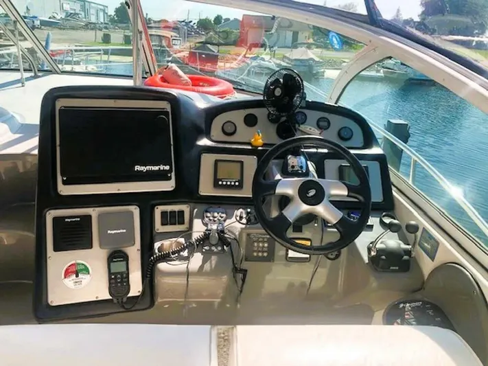  Yacht Photos Pics 2006 Cruisers Yachts 420 Express helm with navigation equipment and steering wheel.