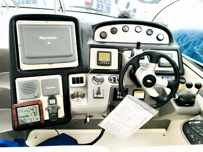  Yacht Photos Pics Control panel of a 2006 Cruisers Yachts 420 Express with navigation equipment and steering wheel.