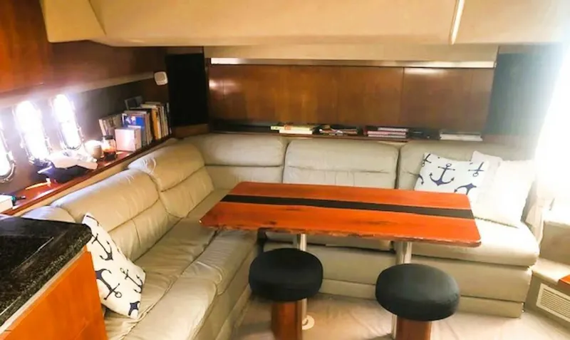  Yacht Photos Pics Interior of 2006 Cruisers Yachts 420 Express with cozy seating and wooden table.