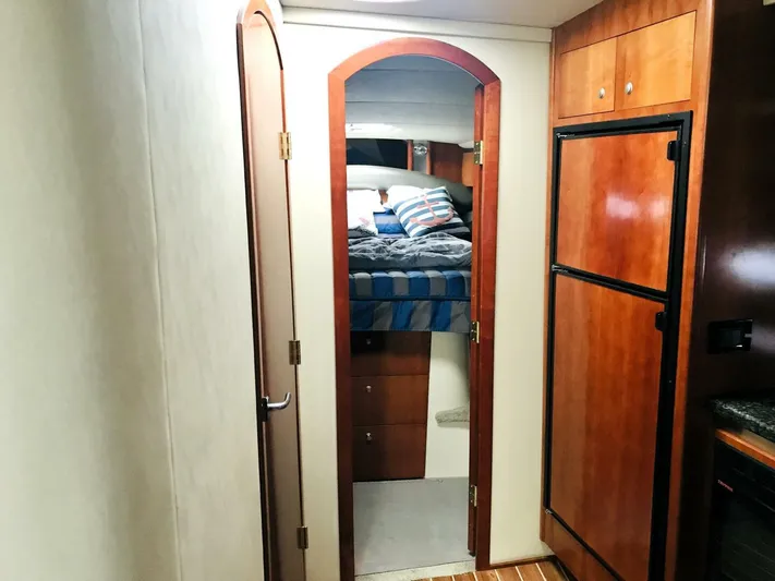  Yacht Photos Pics Interior cabin of 2006 Cruisers Yachts 420 Express with bed and wooden cabinetry.