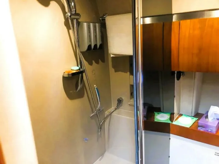  Yacht Photos Pics Bathroom interior of 2006 Cruisers Yachts 420 Express with shower and wooden cabinetry.