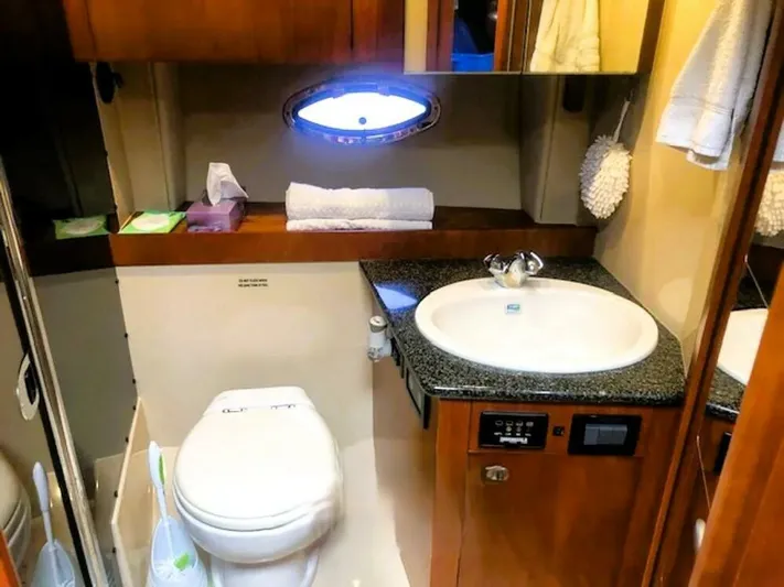  Yacht Photos Pics Luxurious bathroom in 2006 Cruisers Yachts 420 Express with modern amenities.