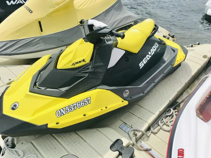  Yacht Photos Pics Yellow Sea-Doo Spark jet ski docked on water, featuring bold design and sporty appearance.