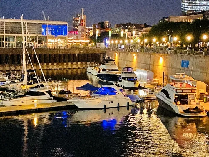  Yacht Photos Pics Marina at night with 2006 Cruisers Yachts 420 Express docked among other boats.