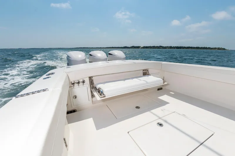 Hi Yacht Photos Pics 2020 Regulator 34 Center Console boat cruising on open water, clear sky, and distant shoreline.
