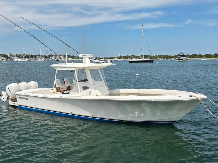 Hi Yacht Photos Pics 2020 Regulator 34 Center Console boat anchored in a scenic harbor.