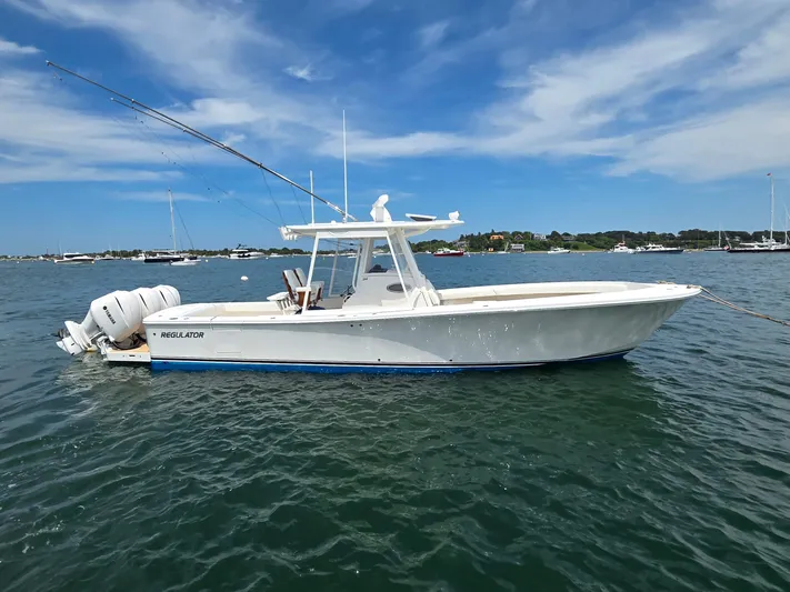 Hi Yacht Photos Pics 2020 Regulator 34 Center Console boat on calm water under blue sky.