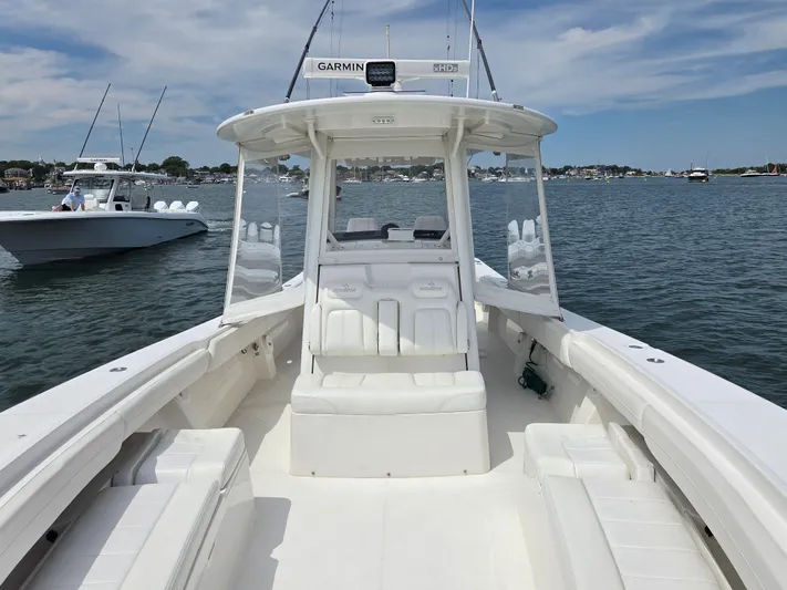 Hi Yacht Photos Pics 2020 Regulator 34 Center Console boat on calm water, featuring spacious seating and Garmin equipment.