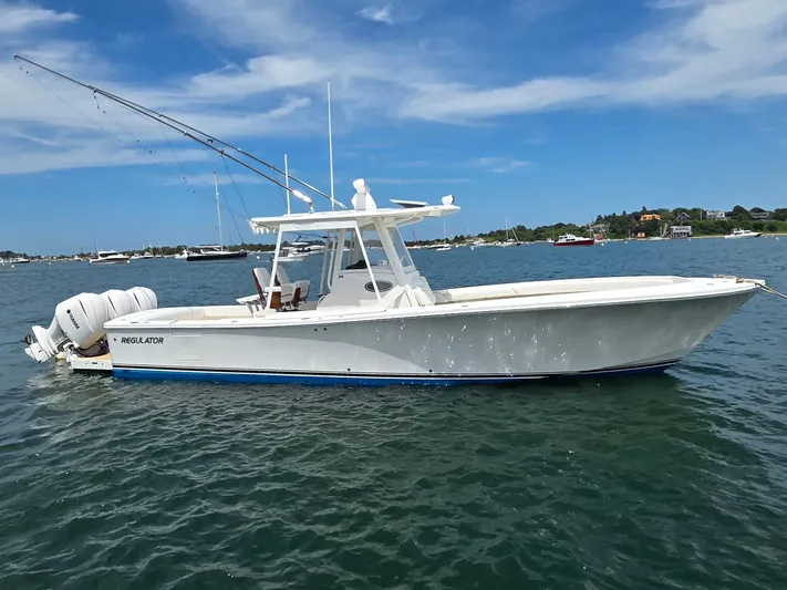 Hi Yacht Photos Pics 2020 Regulator 34 Center Console boat on calm water under blue sky.