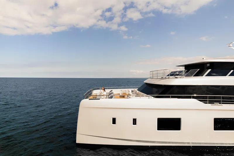  Yacht Photos Pics Luxury 2026 Sunreef 100 Power yacht cruising on open sea under clear skies.