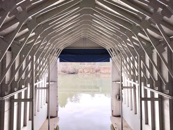  Yacht Photos Pics Interior view of a custom boathouse, 2013, overlooking a serene lake.