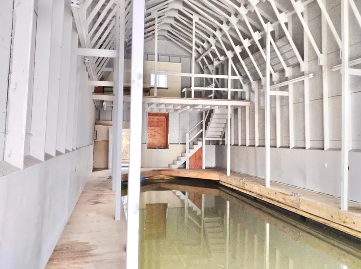  Yacht Photos Pics Spacious custom boathouse interior with wooden beams and indoor waterway, built in 2013.