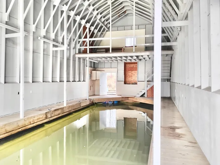  Yacht Photos Pics Spacious custom boathouse interior with wooden beams and indoor waterway, built in 2013.