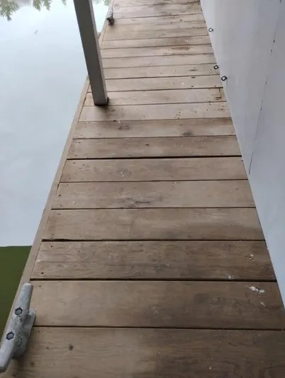  Yacht Photos Pics Wooden dock beside a boathouse, Custom model, 2013, over calm water.