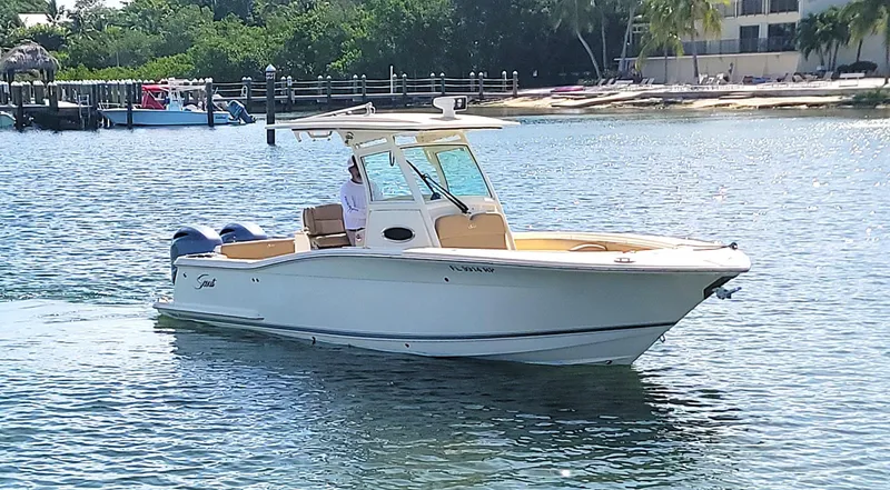  Yacht Photos Pics 2018 Scout 275 LXF boat cruising on a sunny day near a marina.