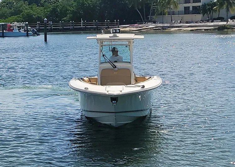  Yacht Photos Pics 2018 Scout 275 LXF boat on calm water near a tropical shoreline.