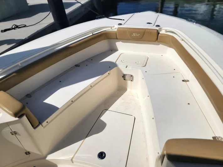  Yacht Photos Pics 2018 Scout 275 LXF boat interior with tan seating and storage compartments.