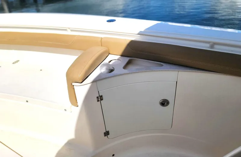  Yacht Photos Pics 2018 Scout 275 LXF boat interior with cushioned seating and storage compartment.