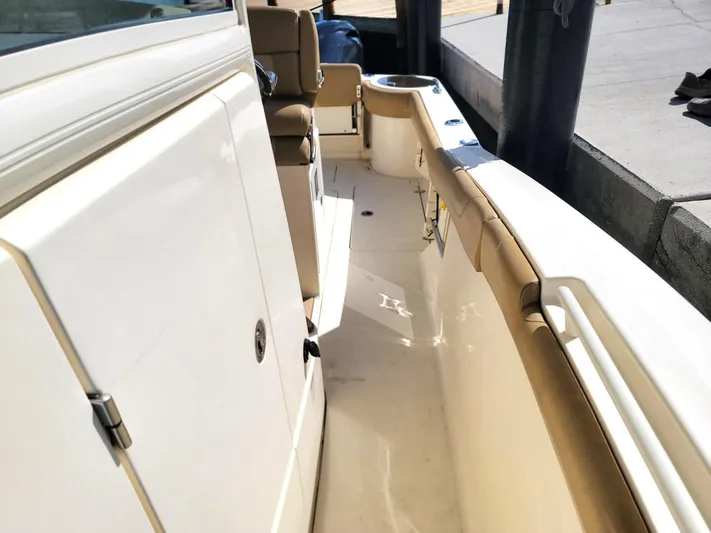  Yacht Photos Pics 2018 Scout 275 LXF boat interior with beige seating and white deck.