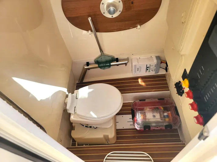  Yacht Photos Pics 2018 Scout 275 LXF boat interior with toilet and storage compartment.