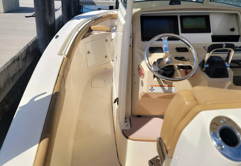  Yacht Photos Pics 2018 Scout 275 LXF boat interior with steering wheel and control panel.