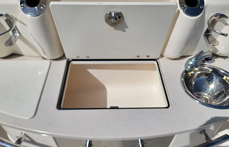  Yacht Photos Pics 2018 Scout 275 LXF boat interior with sink and storage compartment.