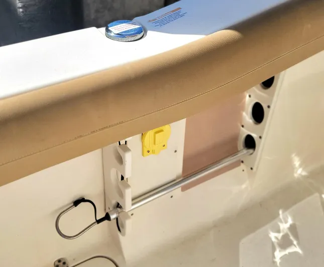  Yacht Photos Pics 2018 Scout 275 LXF boat interior detail with beige upholstery and fishing rod holders.