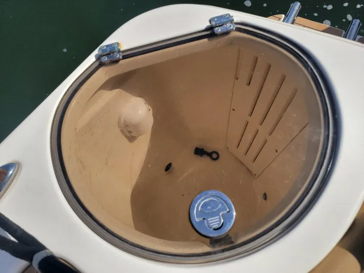  Yacht Photos Pics Open compartment on 2018 Scout 275 LXF boat, showing interior details and latch.