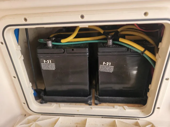  Yacht Photos Pics Batteries in a 2018 Scout 275 LXF boat compartment with yellow and green cables.