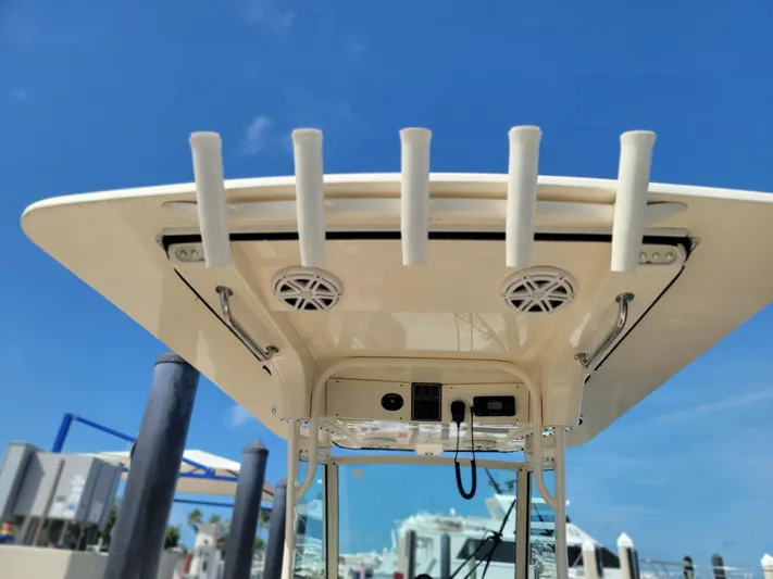  Yacht Photos Pics 2018 Scout 275 LXF boat roof with rod holders and speakers under clear blue sky.