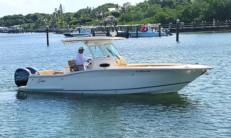  Yacht Photos Pics 2018 Scout 275 LXF boat cruising on a sunny day in a scenic waterway.