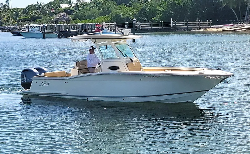  Yacht Photos Pics 2018 Scout 275 LXF boat cruising on a sunny day in calm waters.