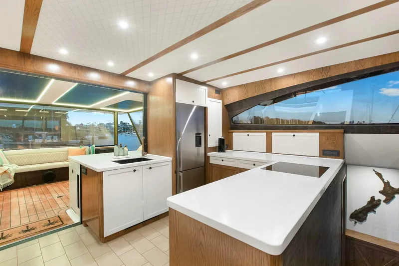 "the Keys" Yacht Photos Pics Luxurious interior of 2021 Custom Valder Yachts Powercat with modern kitchen and seating area.