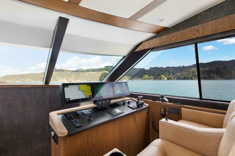 "the Keys" Yacht Photos Pics Interior of 2021 Custom Valder Yachts Powercat, featuring navigation controls and scenic window view.
