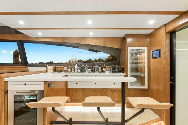 "the Keys" Yacht Photos Pics Luxurious interior of 2021 Valder Yachts Powercat with modern bar and seating area.