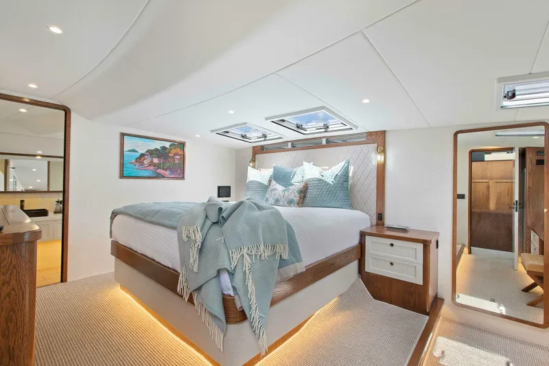 "the Keys" Yacht Photos Pics Luxurious bedroom interior of 2021 Custom Valder Yachts Powercat, featuring elegant bedding and modern design.