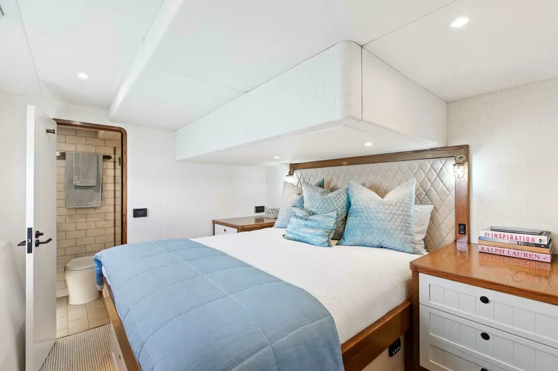 "the Keys" Yacht Photos Pics Luxurious bedroom on 2021 Valder Yachts Powercat with elegant decor and ensuite bathroom.