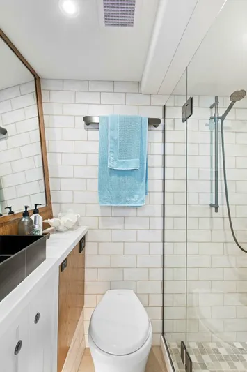 "the Keys" Yacht Photos Pics Modern bathroom in 2021 Valder Yachts Powercat with glass shower and sleek fixtures.