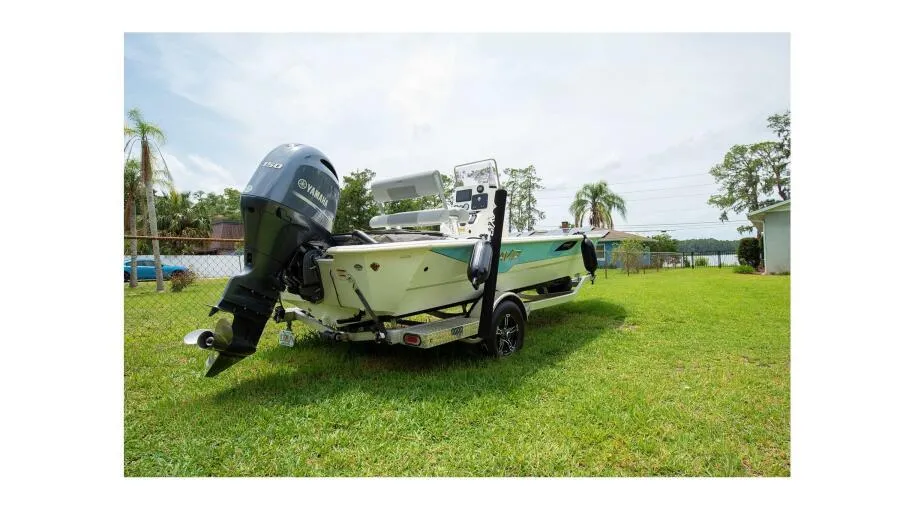 2022 Avid 21 Fusion boat with Yamaha outboard motor on grassy lawn.