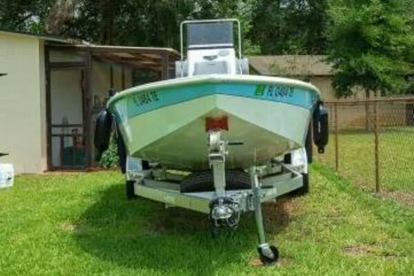 2022 Avid 21 Fusion boat on trailer, parked on grass near a house.