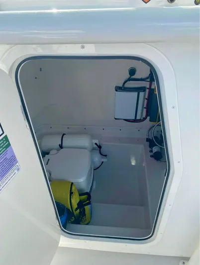  Yacht Photos Pics 2022 Parker 2801 Center Console boat storage compartment with safety equipment.
