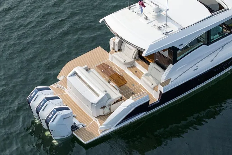  Yacht Photos Pics Manufacturer Provided Image: 2025 Tiara Yachts 48 LE luxury boat with triple outboard engines on water.
