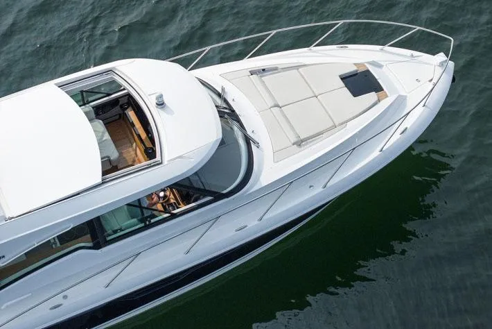 Yacht Photos Pics Manufacturer Provided Image: 2025 Tiara Yachts 48 LE luxury yacht cruising on water, top view.
